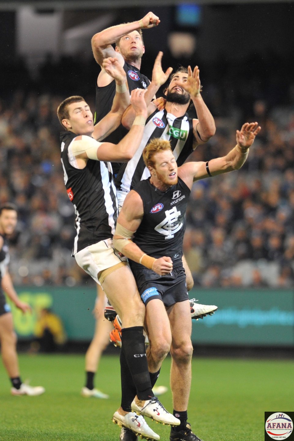 Carltons Sam Rowe gets the high spot as Brodie Grundy challenges, ruckmen Mason Cox and Andrew Phillips add to the carnage