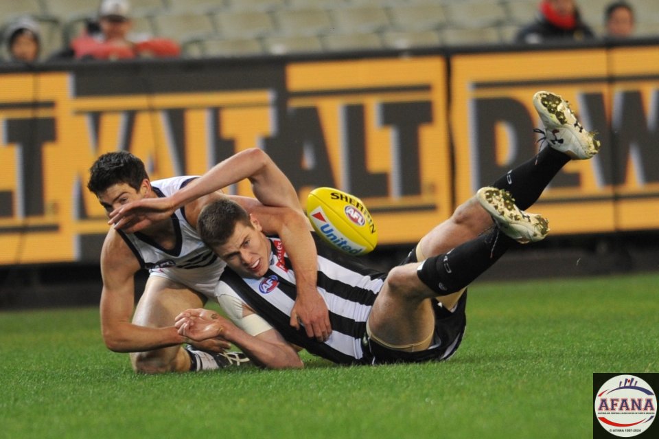 Mason Cox is tackled by Sam Collins