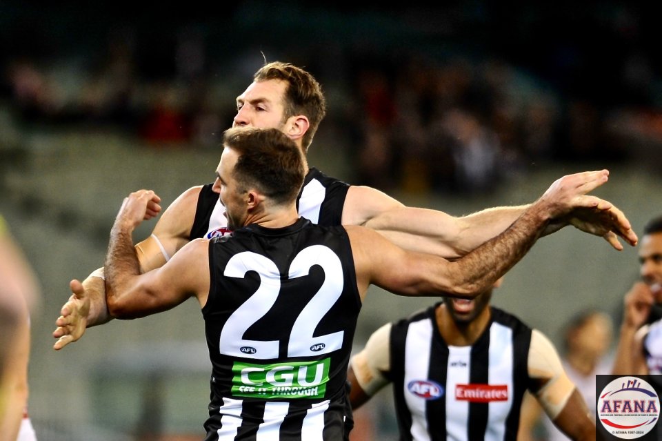 Steele Sidebottom celebrates Travis Cloke's goal after he scored for the Pies on his return