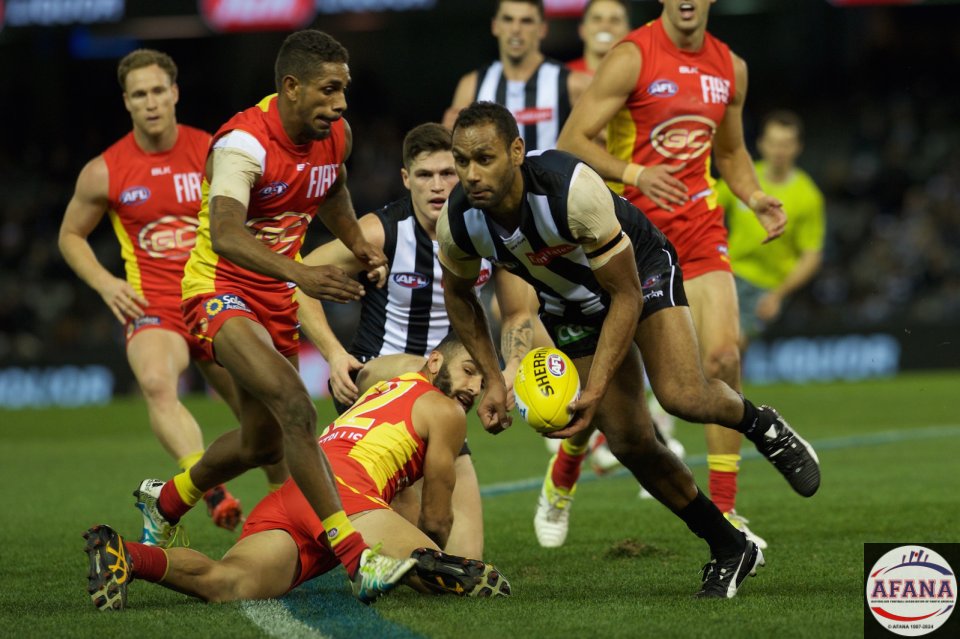 Travis Varcoe clears the ball in as Adam Saad and Touk Miller contest