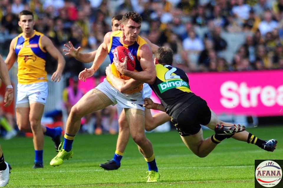 Luke Shuey is tackled by Dylan Grimes (2)
