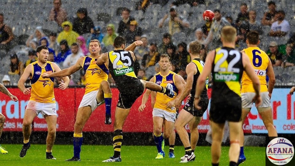 Pouring rain drenches the centre ball up as Vardy and Nankervies contest (25)
